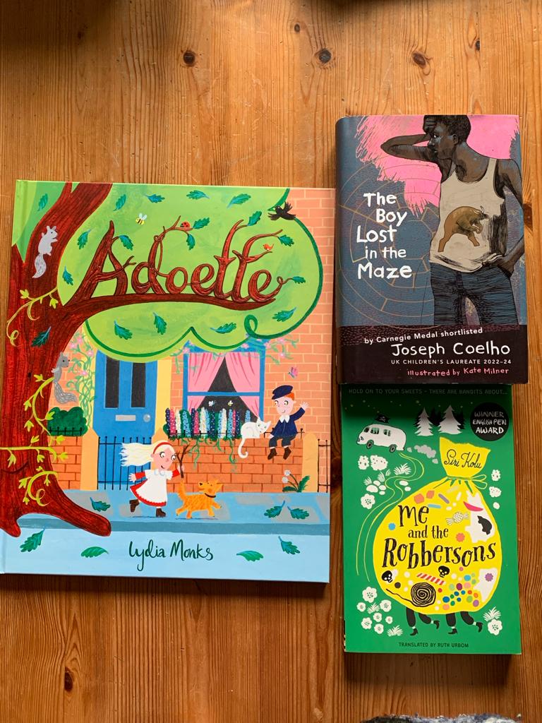 Picture showing the three covers of the nominated books. 'Adoette' is on the left, 'The Boy Lost in the Maze' on the top right, and 'Me and the Robbersons' on the bottom right.